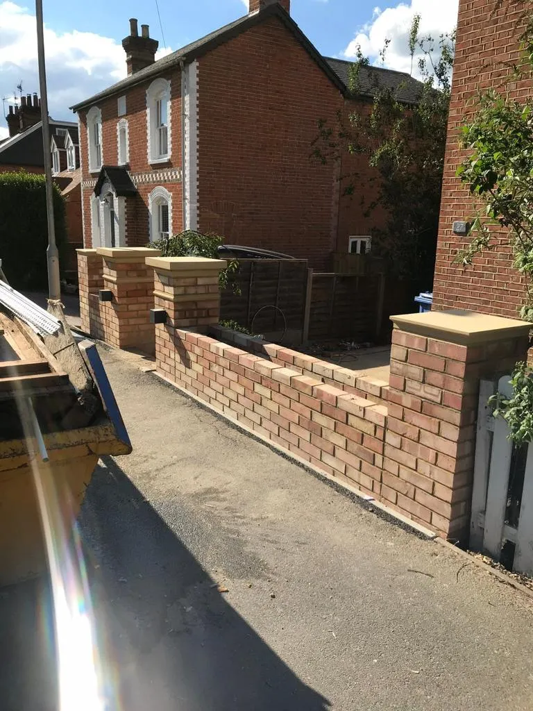 a brick wall next to a brick house